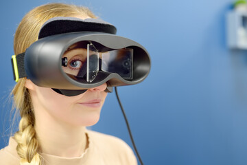 Neurologist performing positional testing of patient using videonystagmography . 