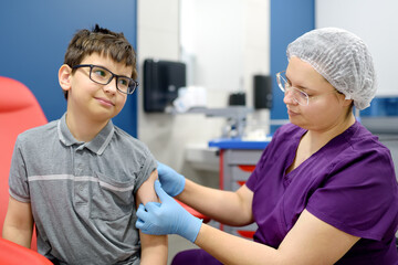 A boy is being vaccinated. A child is given a vaccine during an epidemic or outbreak of a disease.