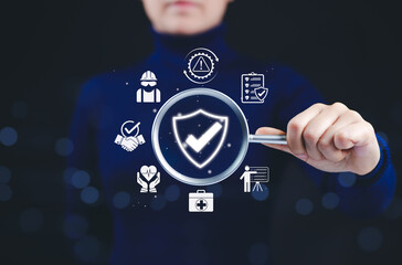 Work safety and compliance inspection concept. Woman holding magnifying glass with icons work...