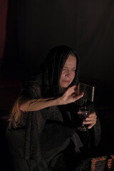 Older adult woman with dramatic gestures on theatrical stage.