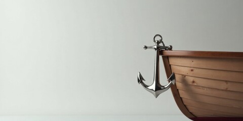 A polished metal anchor hangs from a wooden rowboat against a simple backdrop