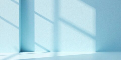 Obraz premium Serene Minimalist Room with Light Streaming Through Window Casts Gentle Shadows on a Pale Blue Wall