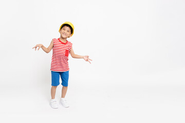 Asian little boy in red striped shirt summer outfits with yellow hat dancing and smiling with backpack isolated on white background, Six years old, Summer Season concepts