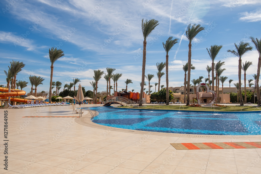 Poster relaxing afternoon by a pool in a resort in egypt with palm trees and clear blue skies