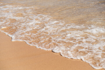 Waves gently lapping on the sandy shore of an Egyptian beach during sunset, creating a serene atmosphere