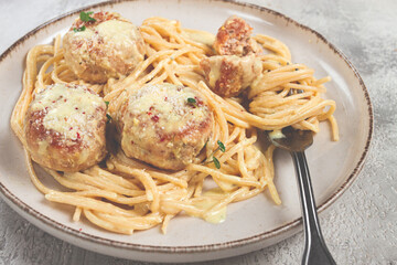 spaghetti with chicken meatballs, with cream sauce, and parmesan cheese, and decorated with microgreens, homemade, no people,