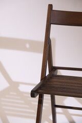 brown chair against a white wall