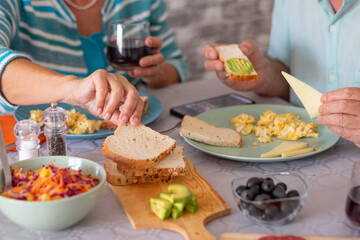 Closeup on caucasian senior couple sitting at kitchen table having a brunch at home enjoying healthy eating