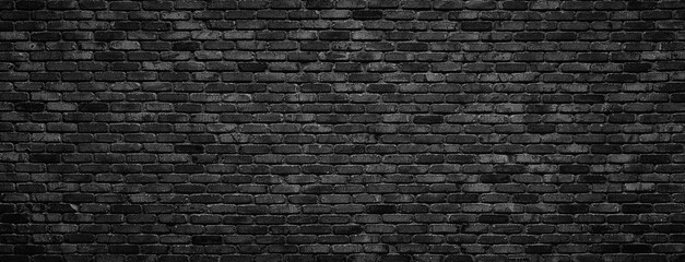 old blackened brick wall background, dark texture of rough brickwork