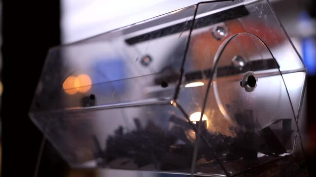 Close-up of the rotation of a transparent lottery reel with lottery tickets