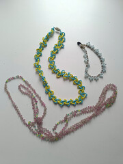 Three thin beaded necklaces in different colors. Handcrafted neck jewelry