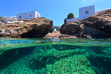 Underwater split photo of iconic small chapel of Chrysopigi built on as small peninsula surrounded...