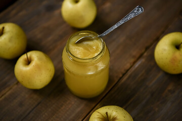 Apple jam. Delicious apple jam and fruits on wooden table. 
