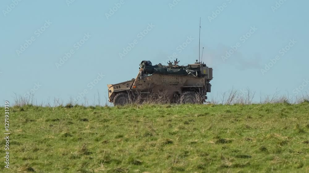 Canvas Prints a British army Foxhound vehicle moving along a dirt track