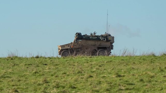 a British army Foxhound vehicle moving along a dirt track