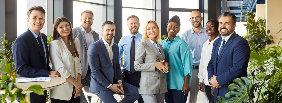 Portrait of a multinational group of happy business people in an office setting. Team strong collaboration and partnership, working together in a professional environment that values teamwork.
