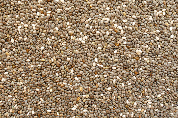Heap of chia seeds as background, texture, top view. Pile of healthy chia seeds, background, texture, close-up. Heap of chia seeds close-up, background, texture, top view.