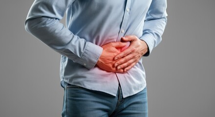 Man holding his stomach in pain due to discomfort or illness