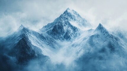 Obraz premium Majestic snow covered mountain peaks shrouded in mist and fog
