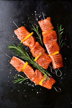 Fresh marinated salmon skewers kebab with spices. Top view with copy space.