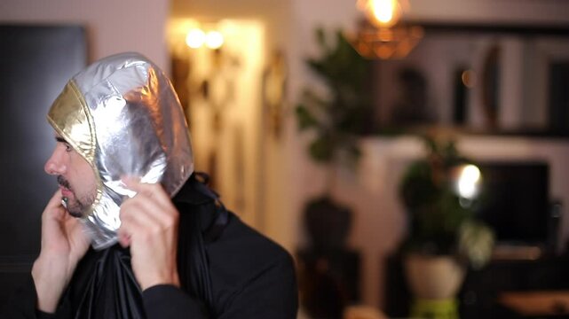 Humorous Video of a Man Struggling to Put on a Small Toy Astronaut Helmet