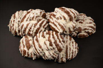 Profiteroles with coconut cream on a black background.