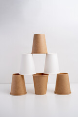 Eco-friendly disposable paper tableware. Paper cup, wooden forks, recycling. Copy space
