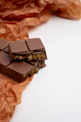 Bar of dark, milk chocolate with filling, Dubai chocolate. Delicious chocolate close-up with nut filling