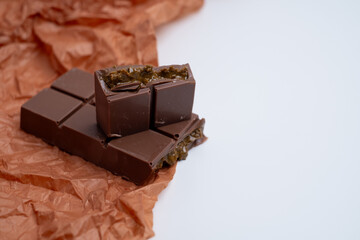 Bar of dark, milk chocolate with filling, Dubai chocolate. Delicious chocolate close-up with nut filling