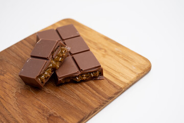 Bar of dark, milk chocolate with filling, Dubai chocolate. Delicious chocolate close-up with nut filling