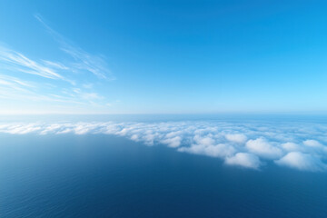 Aerial view of ocean and sky with clouds.