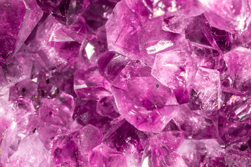 Amethyst pink crystals. Gems. Mineral crystals in the natural environment. Texture of precious and semiprecious stones. Seamless background with copy space colored shiny surface of precious stones.