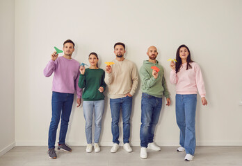 Fototapeta premium Group holding bright paper origami plane, friends new start ready, business, new beginning, life support. Team building event, people together, club to increase motivation and promote cooperation