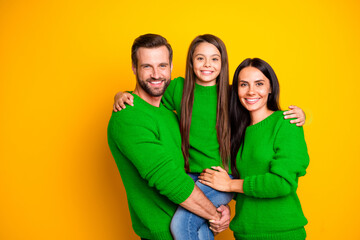 Photo of cheerful cute nice fascinating family embracing each other affectionately wearing jeans...