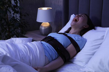 Woman in sleepwalking condition screaming in bed