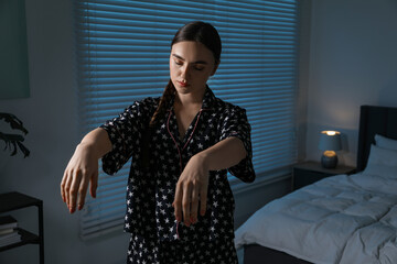 Young woman suffering from sleepwalking at home