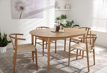 Stylish room with wooden table, chairs and houseplants. Interior design