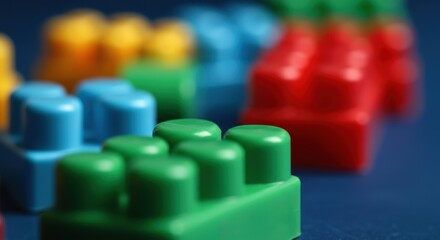 Colorful building blocks in various shapes and sizes on a blue surface