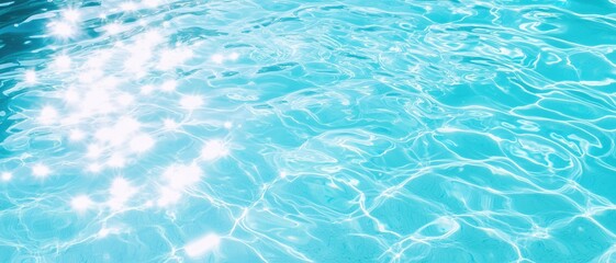 Bright turquoise sunlight caustics dance on soft ripples in a clear swimming pool