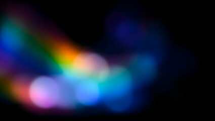 Defocused, abstract light with rainbow hues against a dark background. Colorful, blurry, and artistic with a prism or lens flare effect.