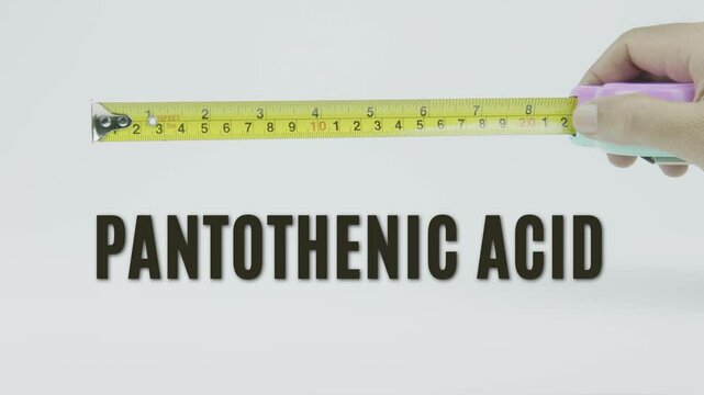 "Pantothenic Acid" text with a yellow tape measure on a white background, symbolizing precision, accuracy, and the measurement of vitamin B5 levels, nutrition, or health benefits in a clean background