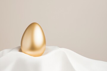 Golden egg is delicately placed on a soft, white silk cloth, symbolizing luxury, prosperity, and new beginnings