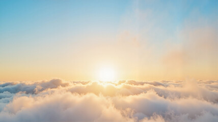 Obraz premium Golden sunrise above soft clouds in clear blue sky, serene beauty