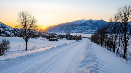 Obraz premium Snowy Road Leading to Mountains at Sunset