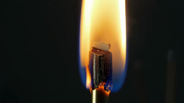 A match is being lit with a close-up view of the flame igniting, highlighting the delicate movement of the fire. Perfect for themes of energy and transformation.