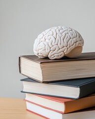 White Brain Model on Stacked Books in Modern Office Setting with Minimalistic Background