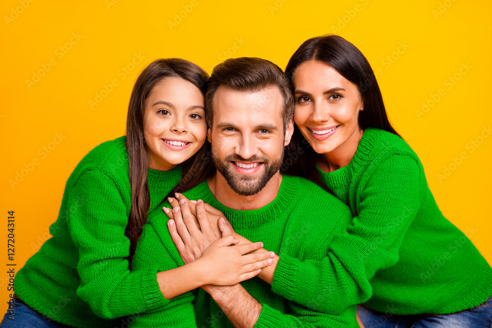 Poster Close up photo of cheerful cute charming nice family hugging dad with daughter and mom cheerful in red sweater and toothy isolated over vivid color yellow background