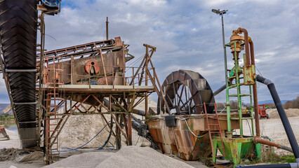 Huge old machine for sand extraction in a lagoon with a mobile conveyor belt