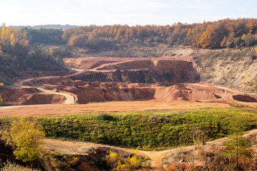 Abandoned bauxite mine with autumn vegetation