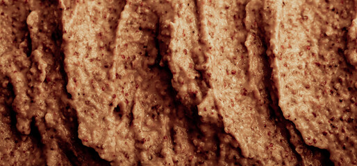 Chocolate ice cream with nuts and banana, texture. Chocolate smoothie cocktail close-up. Nut paste as a background.